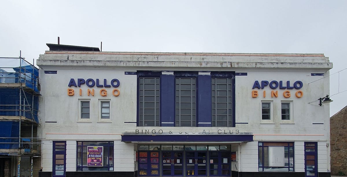 The white art deco style frontage of Apollo Bingo, with its name in blue and orange letters on both sides