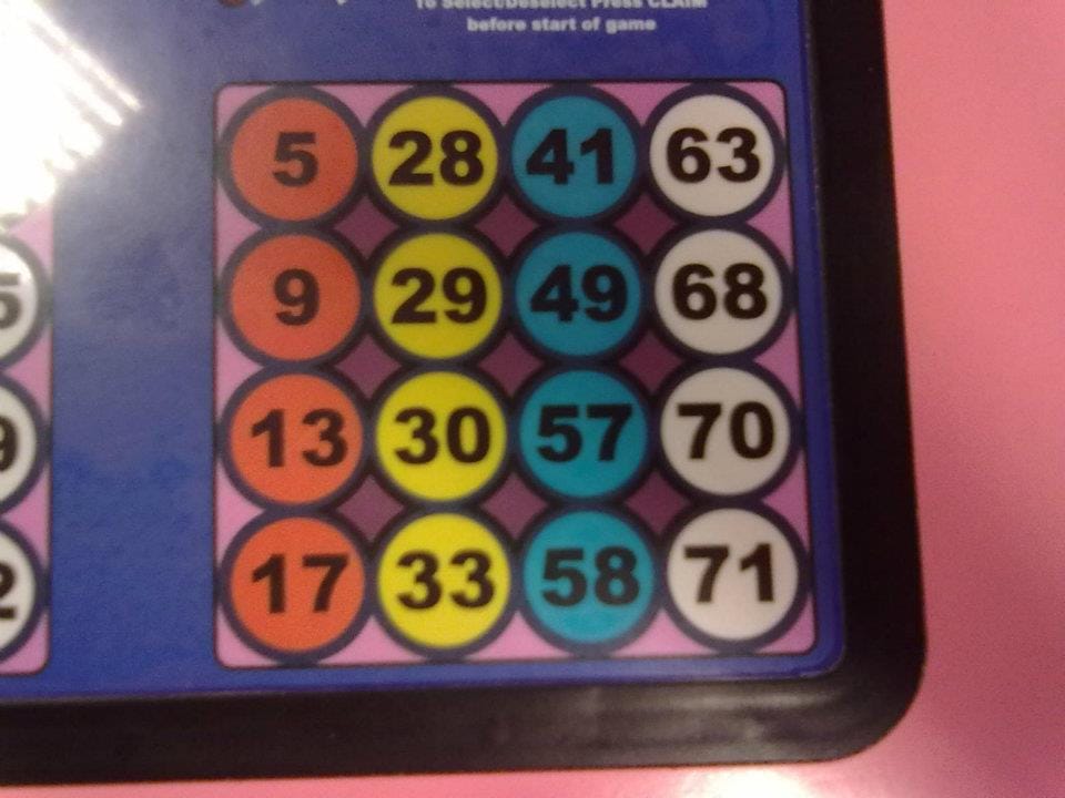 A board of coloured numbered circles in rows, used for mechanised cash bingo