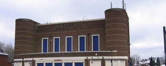 The brick facade of the former Clifton cinema in Perry Barr, with its name above the windows and a round tower at each end