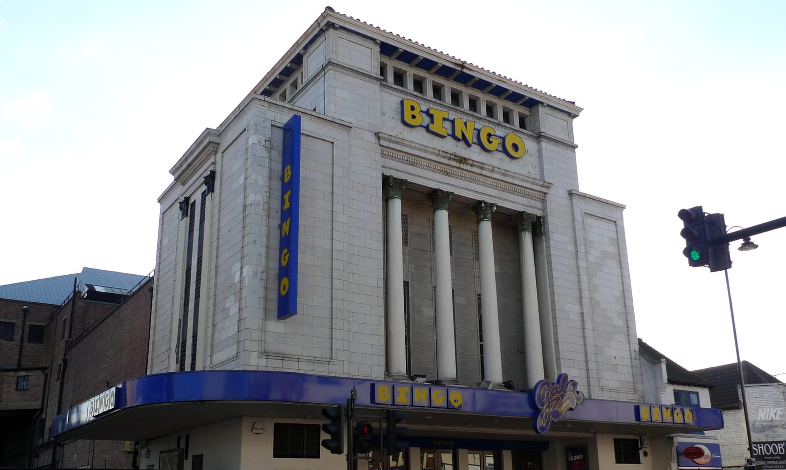 The white columned facade of the former Granada Tooting cinema with BINGO signs in yellow on blue, photographed in 2009