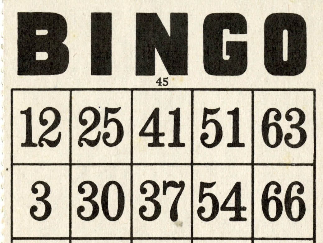 The top of an old black and white bingo card with BINGO in large letters over rows of numbers